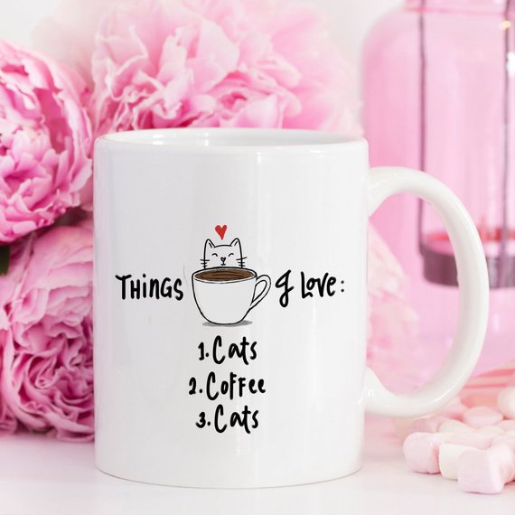 A humorous coffee mug featuring the text 'Things I Love: 1. Cats 2. Coffee 3. Cats', designed for cat lovers.