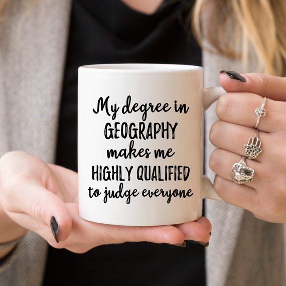 A white ceramic Geographer Mug featuring a vibrant design on both sides, perfect for geography enthusiasts.