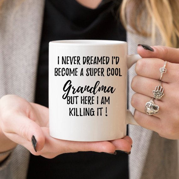 A white ceramic mug with 'Grandma' printed on both sides, showcasing a vibrant design, perfect for gifts.