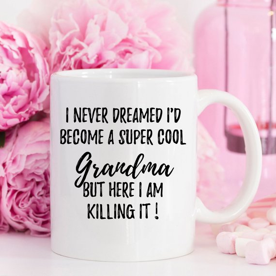 A white ceramic mug with 'Grandma' printed on both sides, showcasing a vibrant design, perfect for gifts.