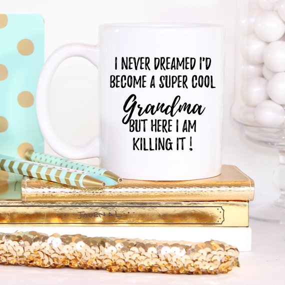 A white ceramic mug with 'Grandma' printed on both sides, showcasing a vibrant design, perfect for gifts.