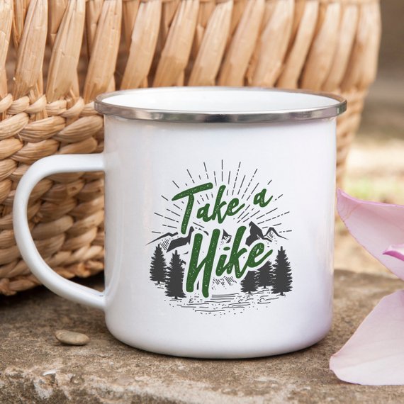 A white enamel mug with a stainless steel rim, featuring a vibrant design on both sides, perfect for hikers and outdoor enthusiasts.