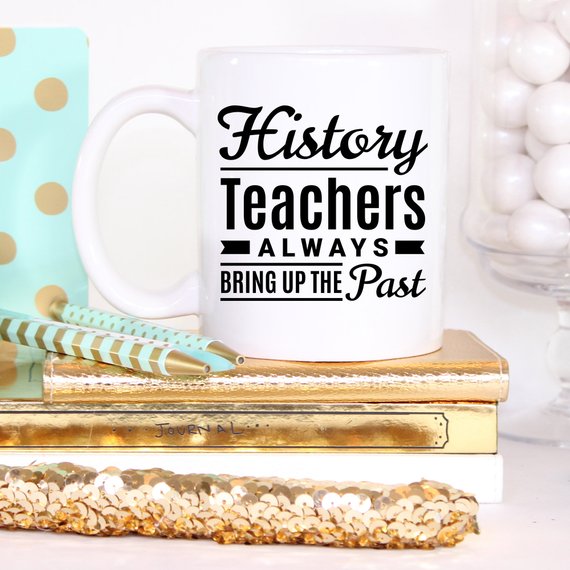 A humorous coffee mug featuring the phrase 'History Teachers Always Bring Up The Past', crafted from high-quality ceramic, ideal for teachers and coffee lovers.