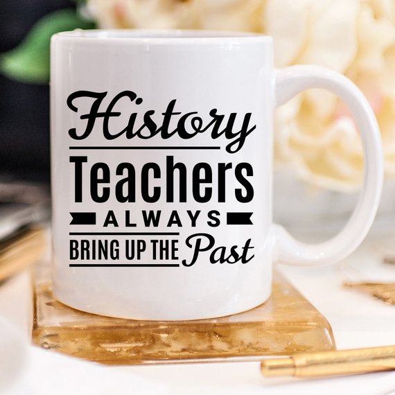 A humorous coffee mug featuring the phrase 'History Teachers Always Bring Up The Past', crafted from high-quality ceramic, ideal for teachers and coffee lovers.