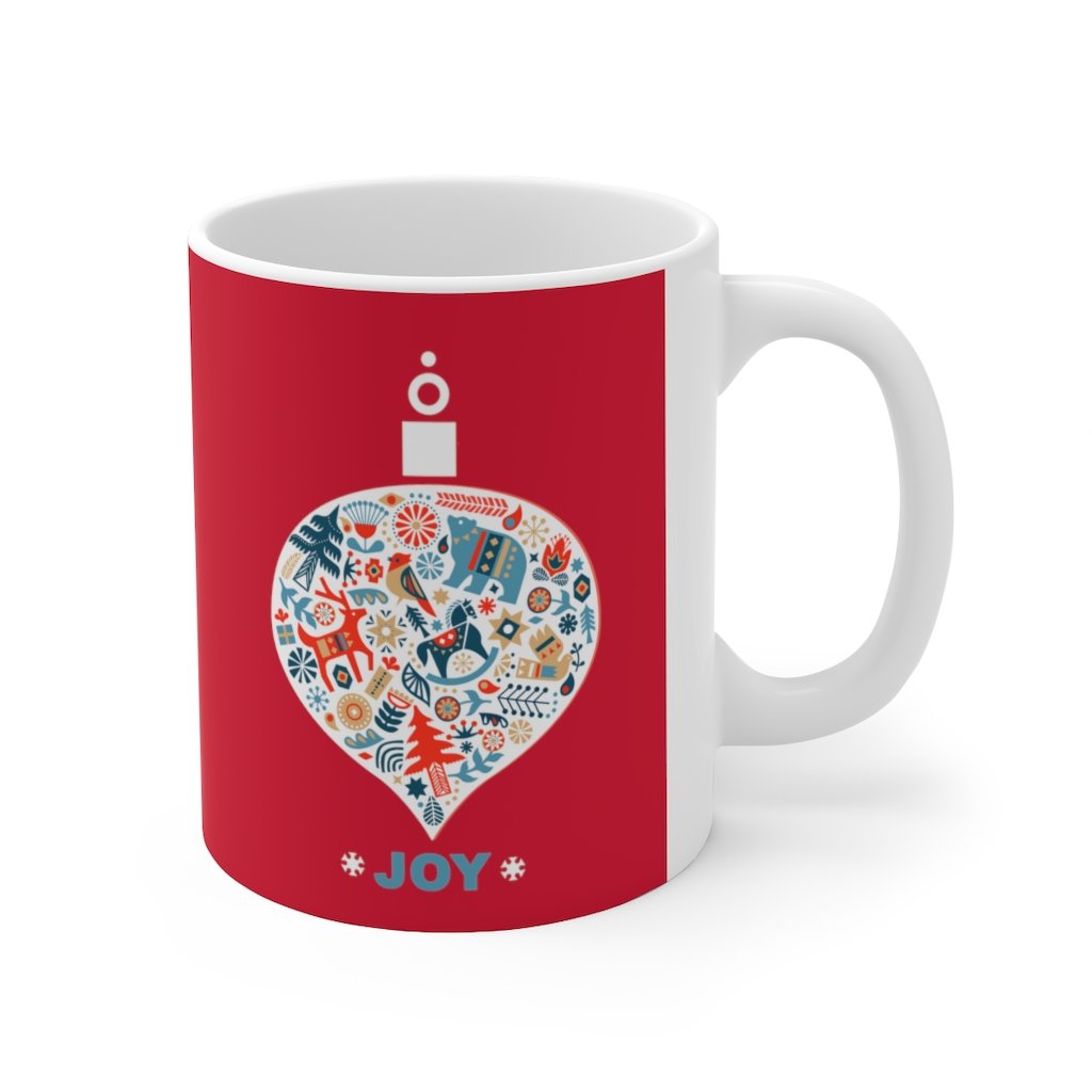 Holiday Ornament with Joy ceramic mug featuring a red backdrop and joyful design, perfect for hot beverages.