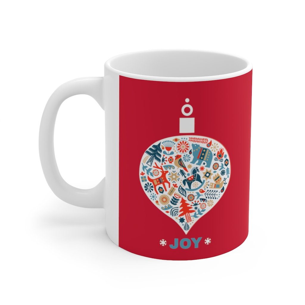 Holiday Ornament with Joy ceramic mug featuring a red backdrop and joyful design, perfect for hot beverages.