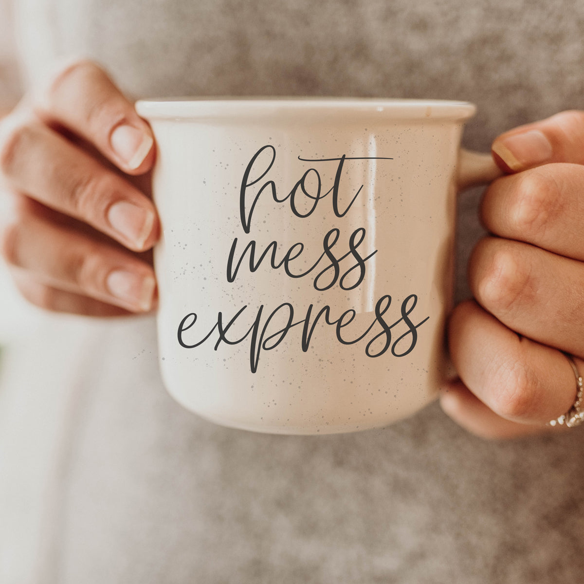 Hot Mess Express 14.5oz ceramic coffee mug with double-sided design featuring humorous lettering, light ivory color with speckles.