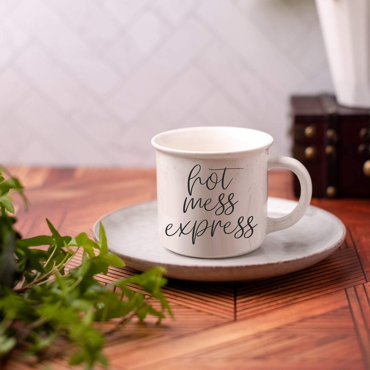 Hot Mess Express 14.5oz ceramic coffee mug with double-sided design featuring humorous lettering, light ivory color with speckles.