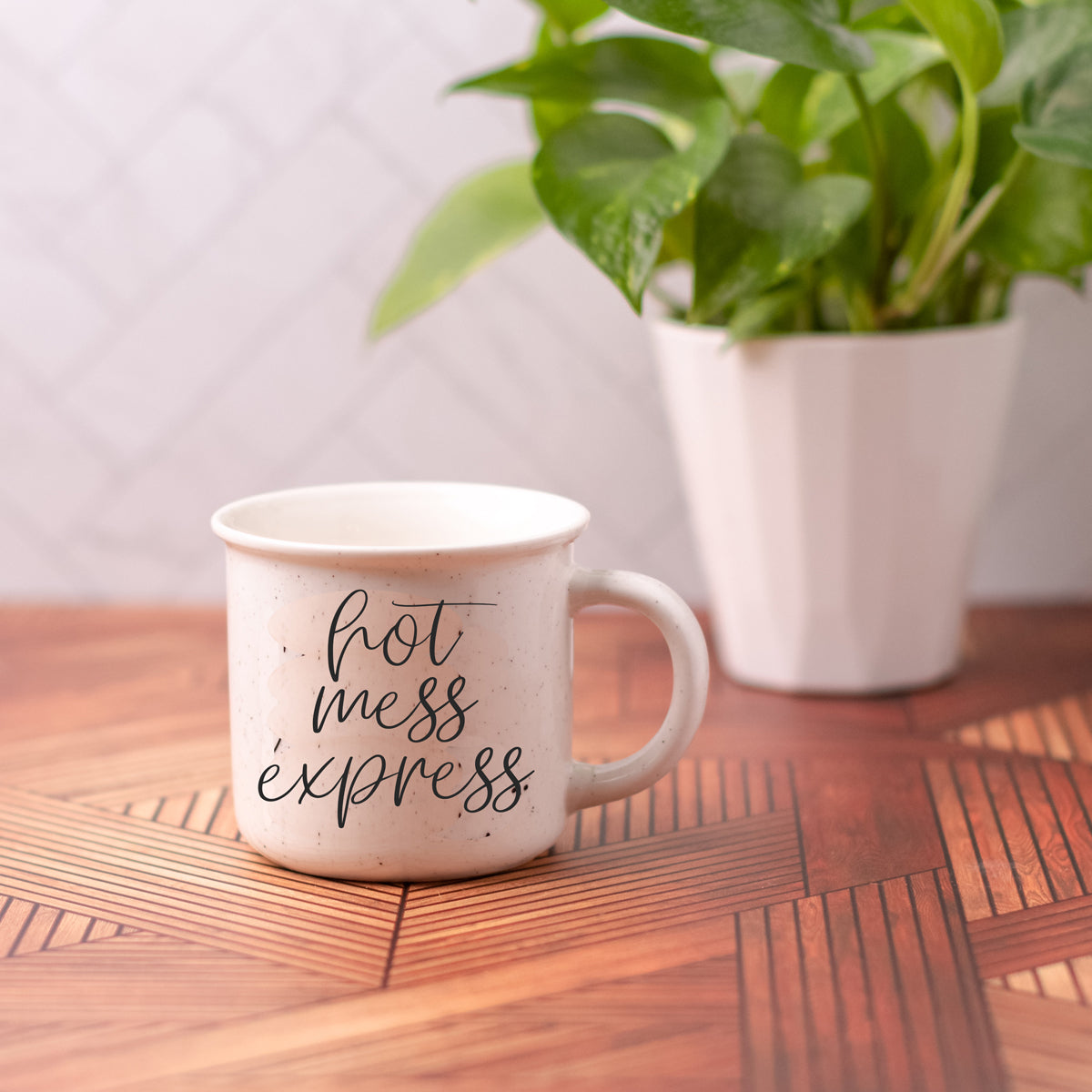 Hot Mess Express 14.5oz ceramic coffee mug with double-sided design featuring humorous lettering, light ivory color with speckles.