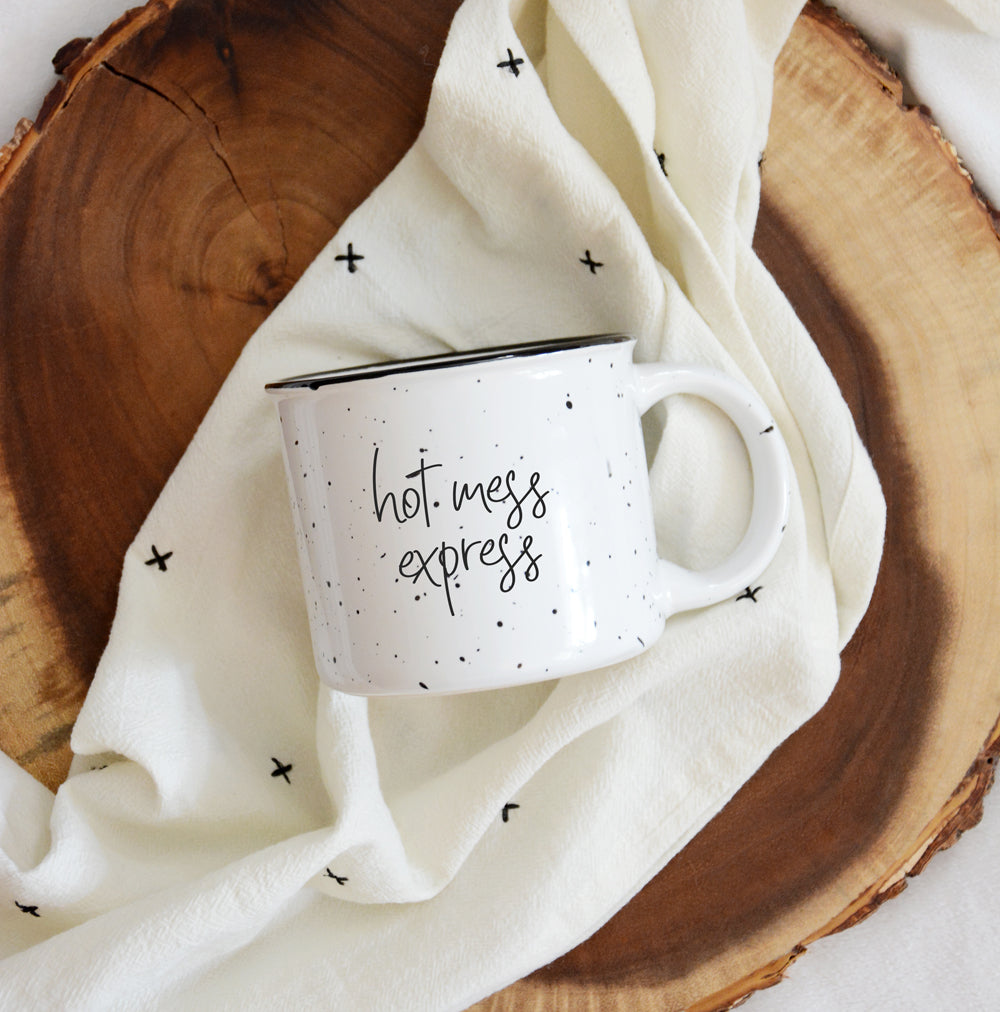 Hot Mess Express oversized campfire mug with black rim, featuring double-sided design and white sesame glaze.