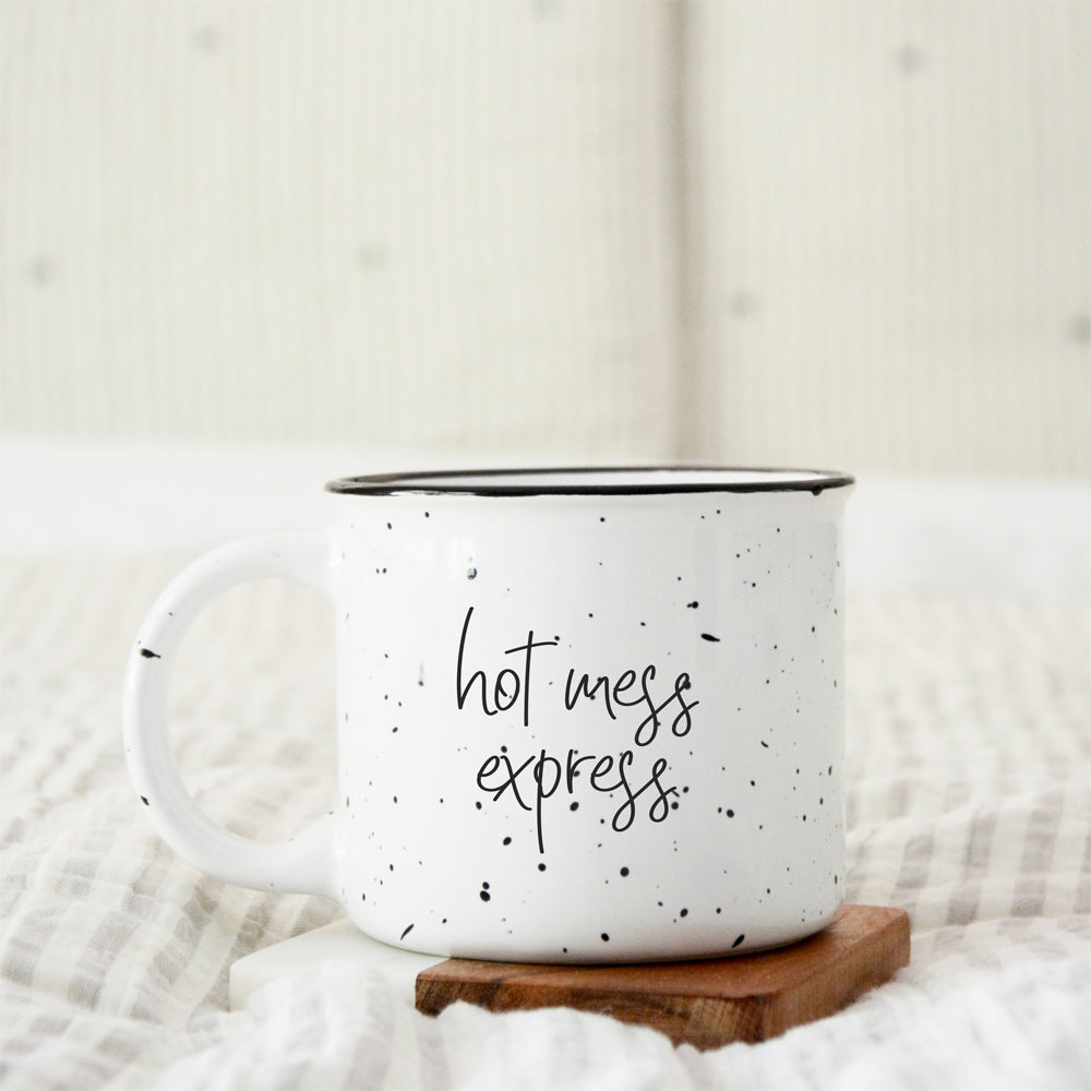 Hot Mess Express oversized campfire mug with black rim, featuring double-sided design and white sesame glaze.