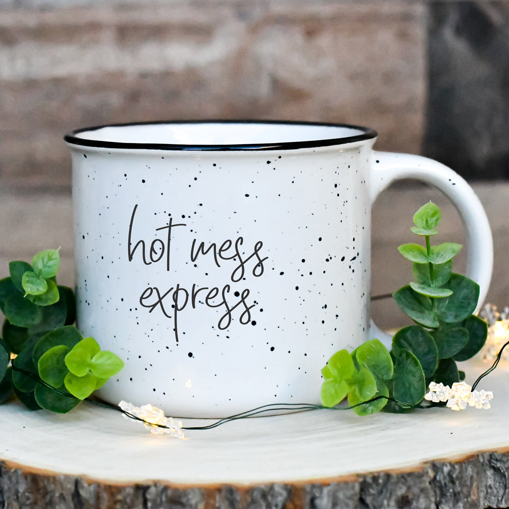 Hot Mess Express oversized campfire mug with black rim, featuring double-sided design and white sesame glaze.