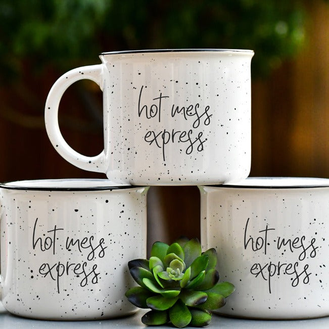 Hot Mess Express oversized campfire mug with black rim, featuring double-sided design and white sesame glaze.