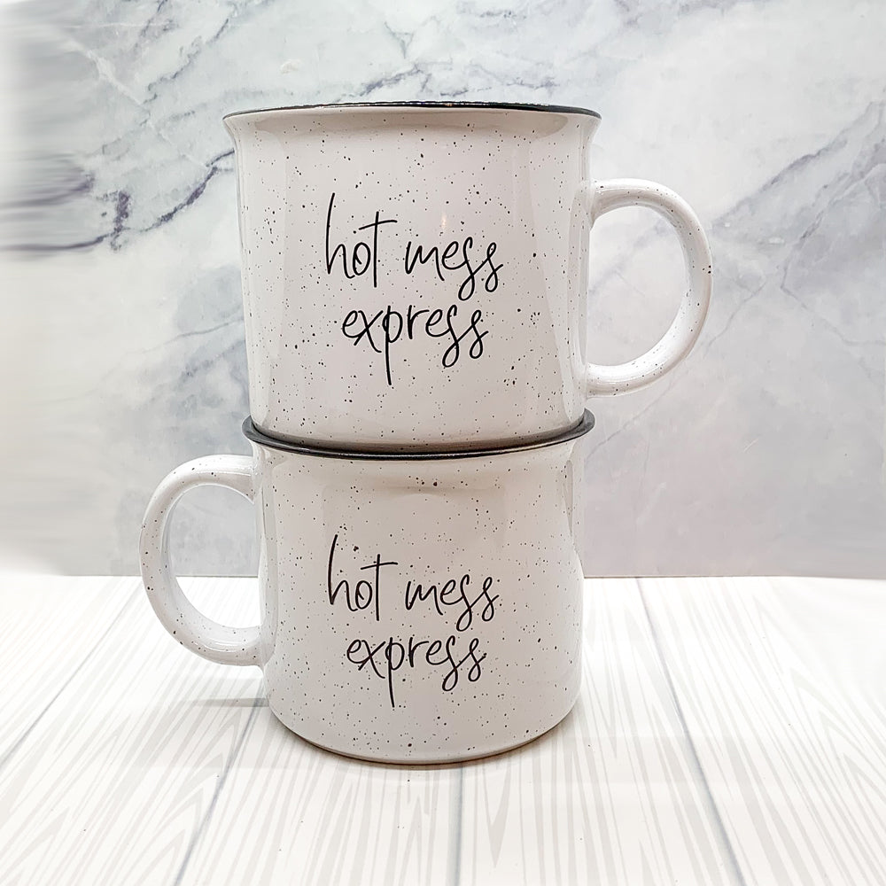 Hot Mess Express oversized campfire mug with black rim, featuring double-sided design and white sesame glaze.