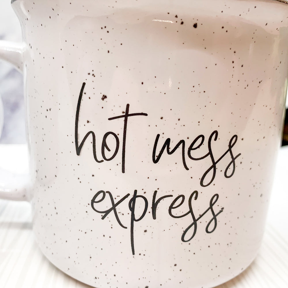 Hot Mess Express oversized campfire mug with black rim, featuring double-sided design and white sesame glaze.