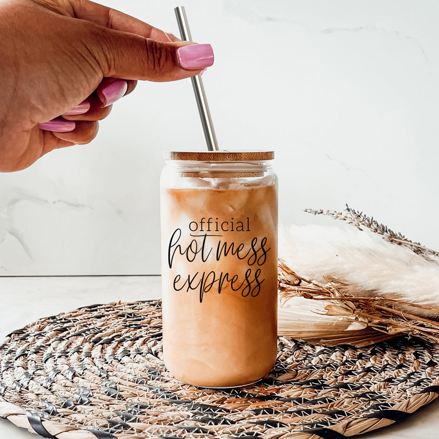 Hot Mess glass drinking cup with bamboo lid and stainless steel straws, showcasing a modern design and black graphic.