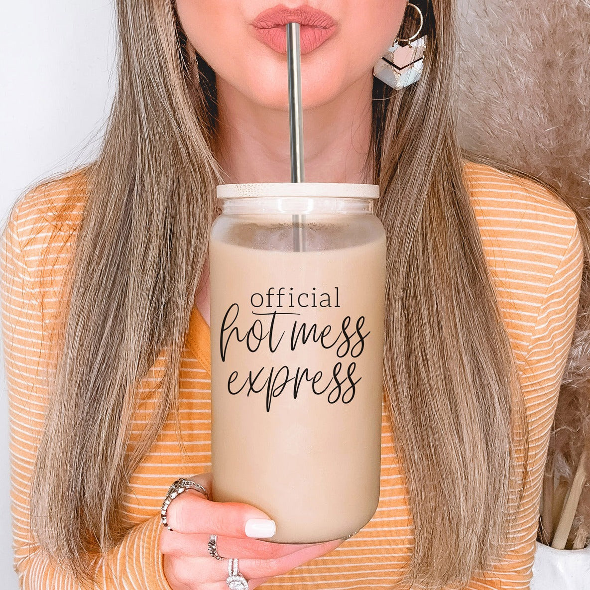 Hot Mess glass drinking cup with bamboo lid and stainless steel straws, showcasing a modern design and black graphic.