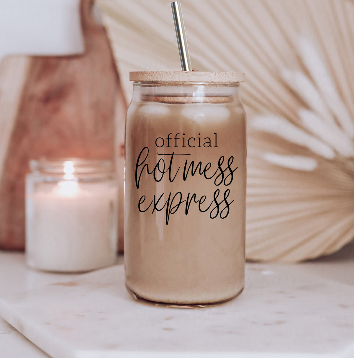 Hot Mess glass drinking cup with bamboo lid and stainless steel straws, showcasing a modern design and black graphic.