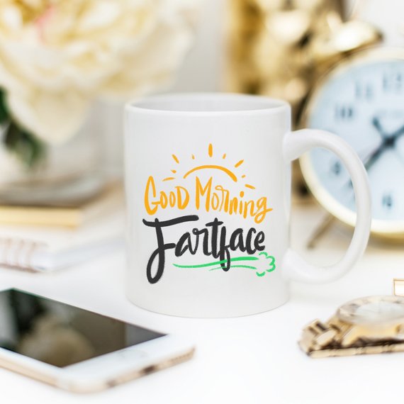 A humorous 'Good Morning Fartface' coffee mug featuring a playful design, perfect for gifting to husbands.