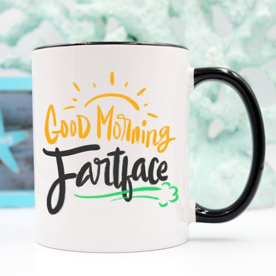 A humorous 'Good Morning Fartface' coffee mug featuring a playful design, perfect for gifting to husbands.