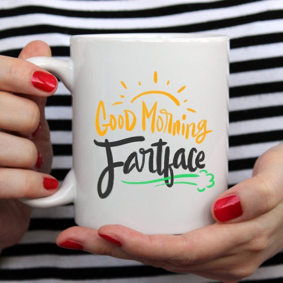 A humorous 'Good Morning Fartface' coffee mug featuring a playful design, perfect for gifting to husbands.