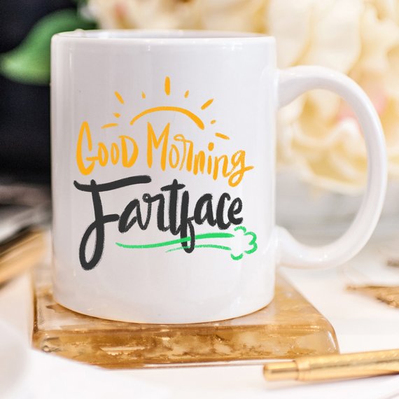 A humorous 'Good Morning Fartface' coffee mug featuring a playful design, perfect for gifting to husbands.