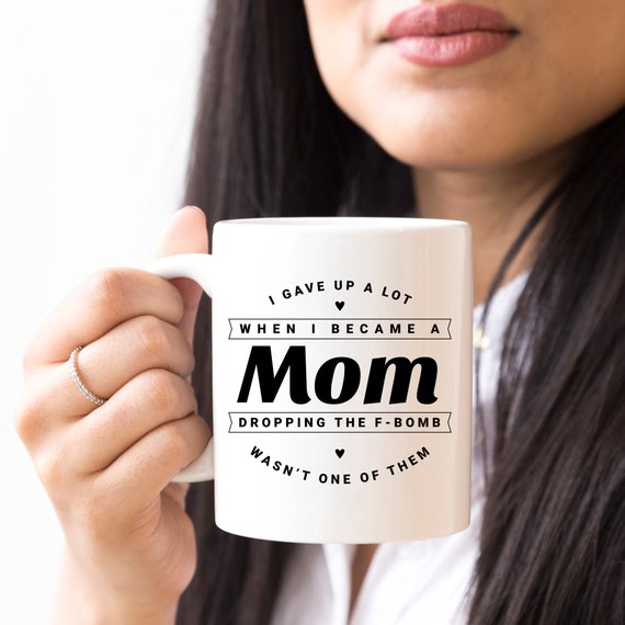 Funny coffee mug with the phrase 'Dropping The F Bomb Wasn't One Of Them', crafted from high-quality ceramic, perfect for moms.