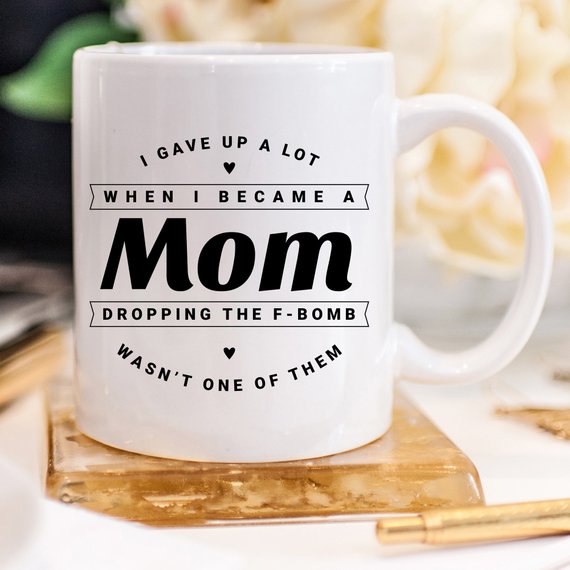 Funny coffee mug with the phrase 'Dropping The F Bomb Wasn't One Of Them', crafted from high-quality ceramic, perfect for moms.