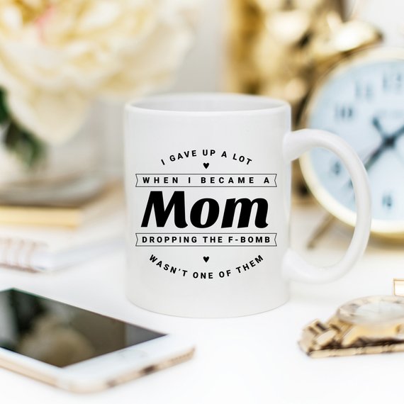 Funny coffee mug with the phrase 'Dropping The F Bomb Wasn't One Of Them', crafted from high-quality ceramic, perfect for moms.