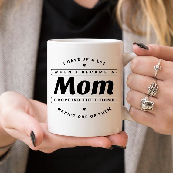 Funny coffee mug with the phrase 'Dropping The F Bomb Wasn't One Of Them', crafted from high-quality ceramic, perfect for moms.