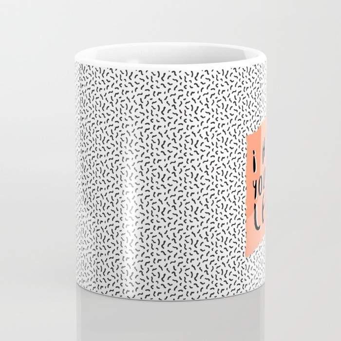 A humorous ceramic coffee mug with the phrase 'I Hate You the Least' printed in a playful font, featuring a wrap-around design and a large handle for easy gripping.