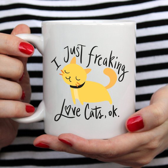 A humorous coffee mug featuring the phrase 'I Just Freaking Love Cats OK', designed for cat lovers, made from high-quality ceramic.