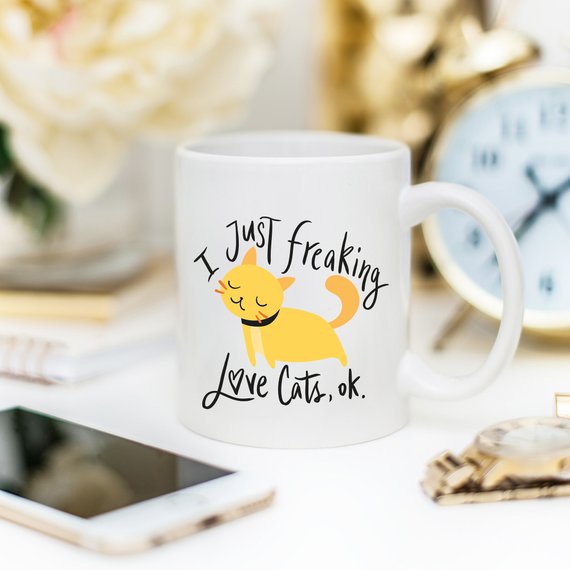 A humorous coffee mug featuring the phrase 'I Just Freaking Love Cats OK', designed for cat lovers, made from high-quality ceramic.