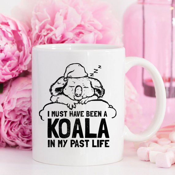 A humorous coffee mug featuring the phrase 'I Must Have Been A Koala In My Past Life', showcasing a playful design perfect for coffee lovers.