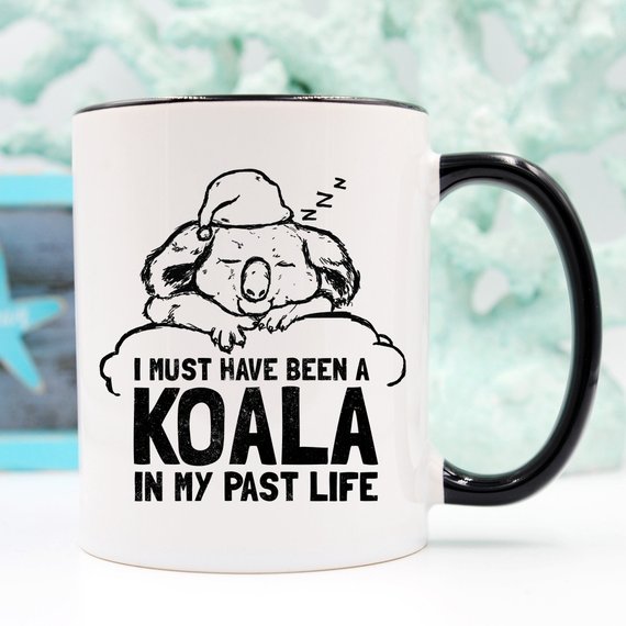 A humorous coffee mug featuring the phrase 'I Must Have Been A Koala In My Past Life', showcasing a playful design perfect for coffee lovers.