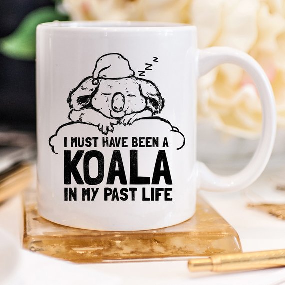 A humorous coffee mug featuring the phrase 'I Must Have Been A Koala In My Past Life', showcasing a playful design perfect for coffee lovers.