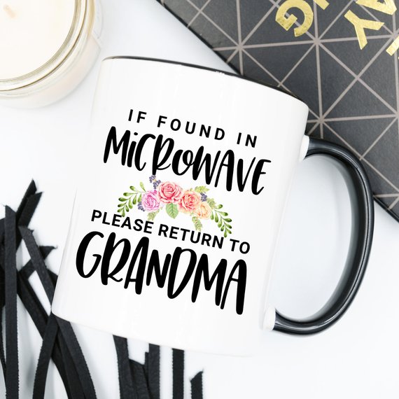 White ceramic mug with humorous text 'If Found In Microwave Please Return to Grandma' printed on both sides, ideal for coffee or tea.