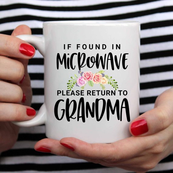 White ceramic mug with humorous text 'If Found In Microwave Please Return to Grandma' printed on both sides, ideal for coffee or tea.