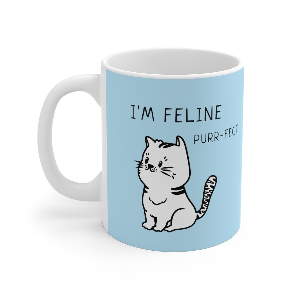 I'm Feline Purr-Fect Mug in Blue, featuring a charming cat design on a white ceramic body, perfect for coffee or tea.