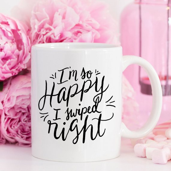 A humorous coffee mug with the phrase 'I'm So Happy I Swiped Right' printed on it, showcasing a fun design perfect for gifts.