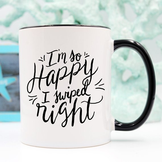 A humorous coffee mug with the phrase 'I'm So Happy I Swiped Right' printed on it, showcasing a fun design perfect for gifts.