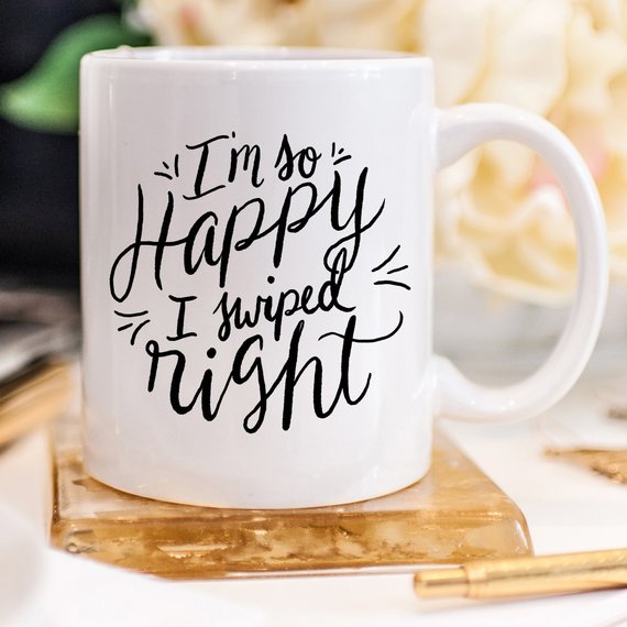 A humorous coffee mug with the phrase 'I'm So Happy I Swiped Right' printed on it, showcasing a fun design perfect for gifts.