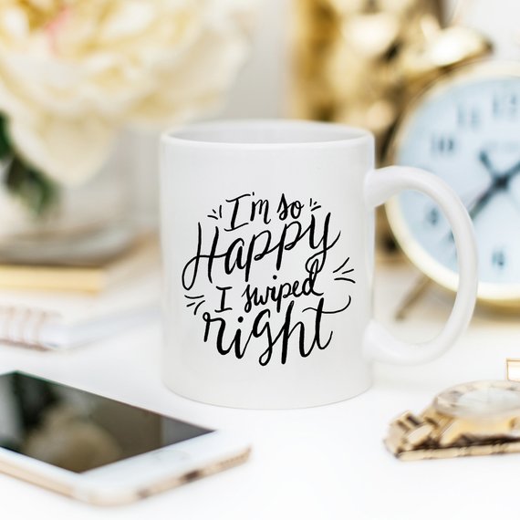 A humorous coffee mug with the phrase 'I'm So Happy I Swiped Right' printed on it, showcasing a fun design perfect for gifts.