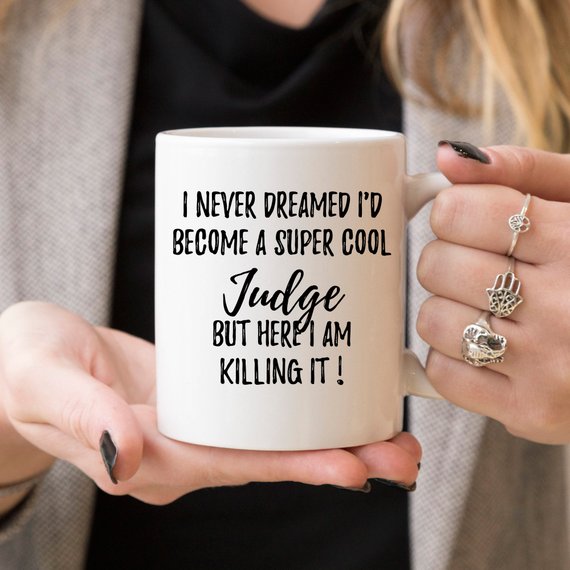 A white ceramic Judge Mug featuring a vibrant design printed on both sides, perfect for gifting judges.