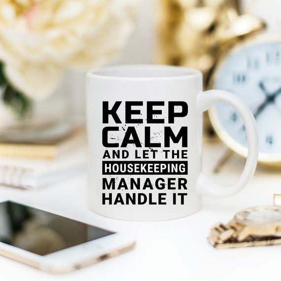 Funny coffee mug with 'Keep Calm And Let The Housekeeping Manager Handle It' design, crafted from high-quality ceramic.