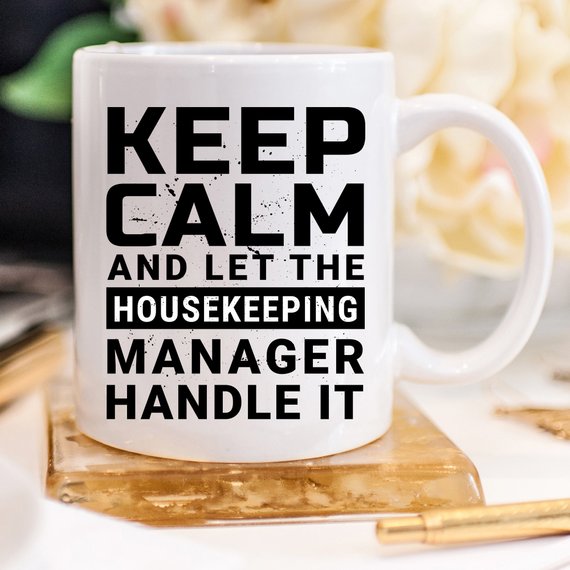 Funny coffee mug with 'Keep Calm And Let The Housekeeping Manager Handle It' design, crafted from high-quality ceramic.