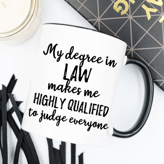 A white ceramic lawyer mug featuring a vibrant legal-themed design on both sides, perfect for coffee or tea.