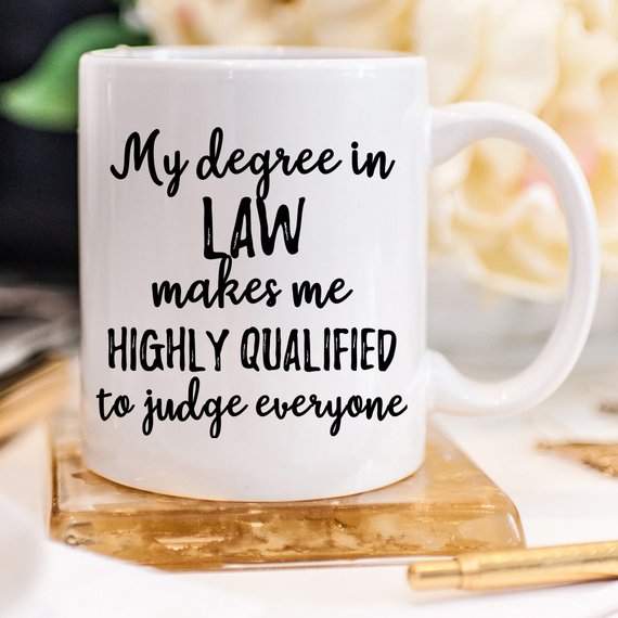 A white ceramic lawyer mug featuring a vibrant legal-themed design on both sides, perfect for coffee or tea.