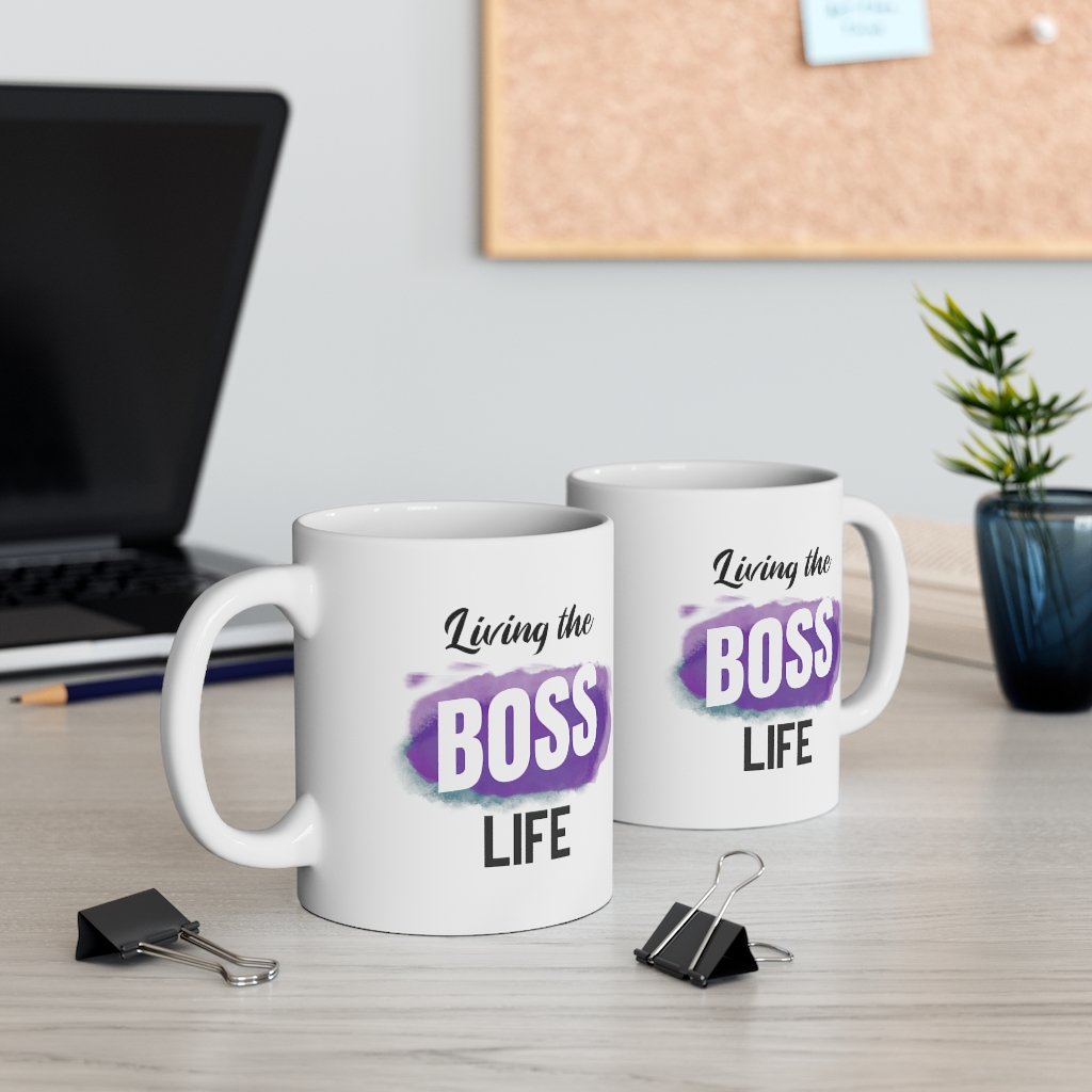 Living A Boss Life Mug made of white ceramic, featuring a motivational phrase and a comfortable C-handle.