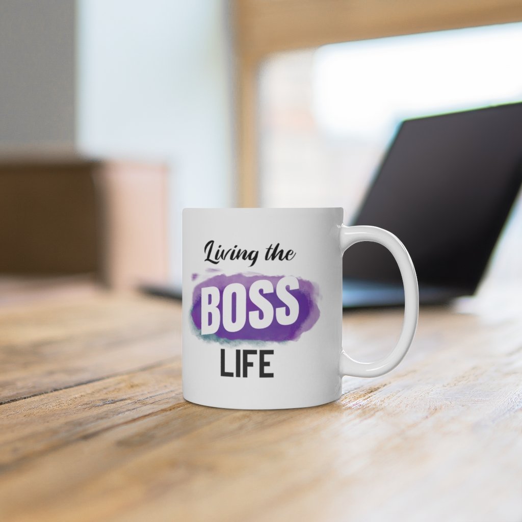 Living A Boss Life Mug made of white ceramic, featuring a motivational phrase and a comfortable C-handle.